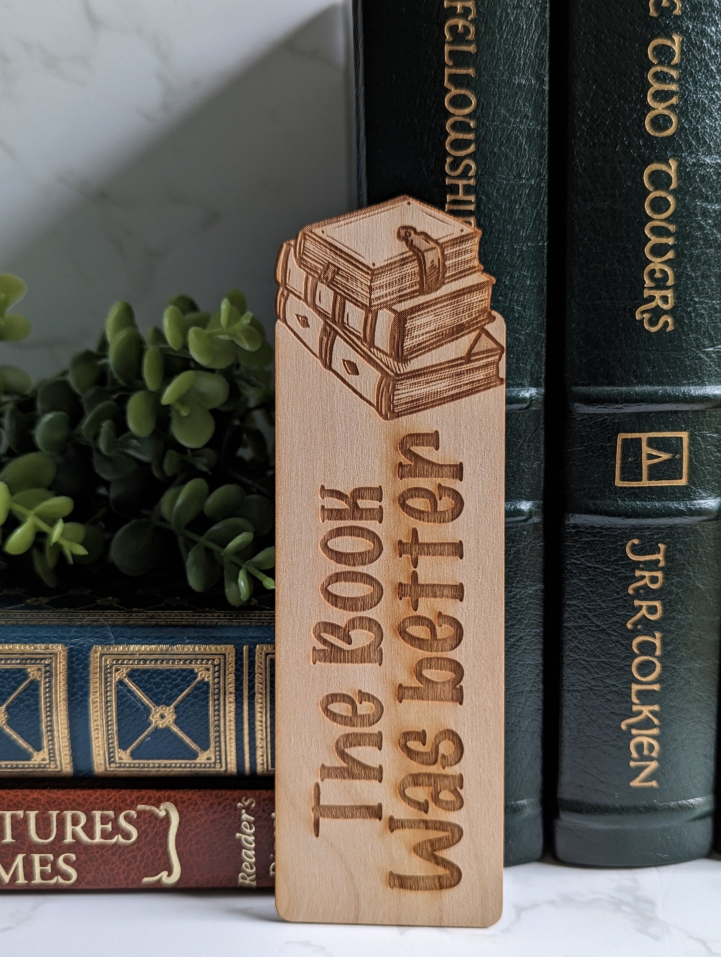 A wooden bookmark that says "the book was better."