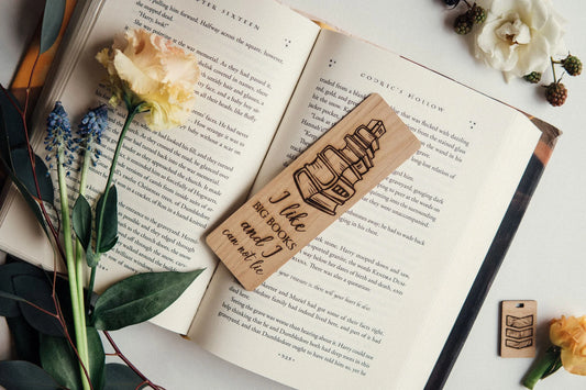 A wooden bookmark is shown that says "I like big books and I cannot lie."