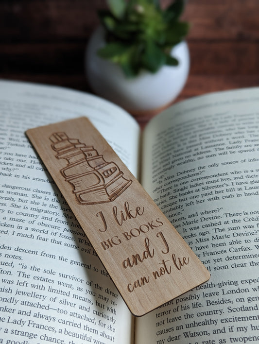 A wooden bookmark is shown that says "I like big books and I cannot lie."