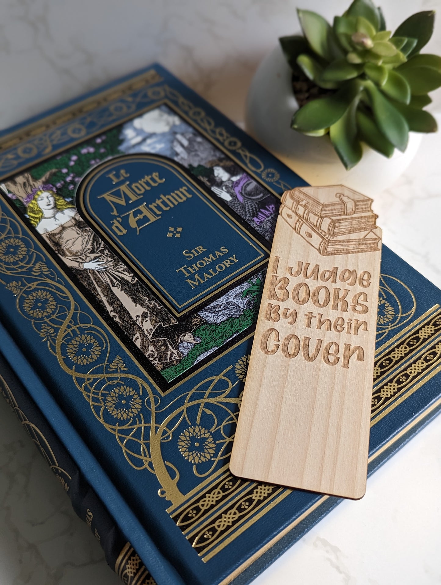Wooden bookmark that says "I judge books by their cover."