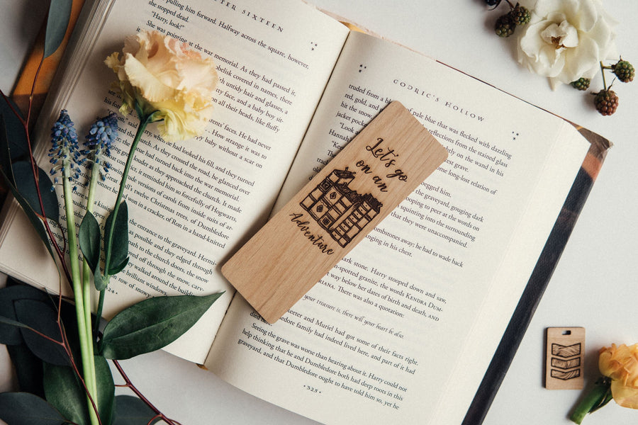 A wooden bookmark that says "let's go on an adventure."