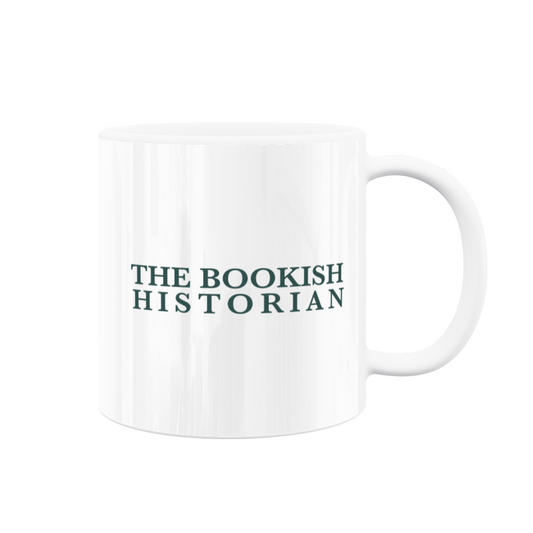 A white mug with the teal "The Bookish Historian" wordmark on it.